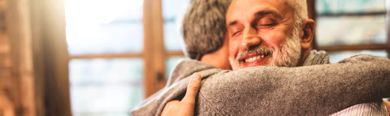man hugging loved one suffering from addiction