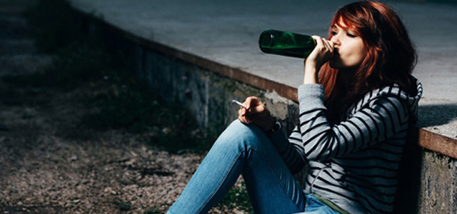 teen girl drinking alcohol alone