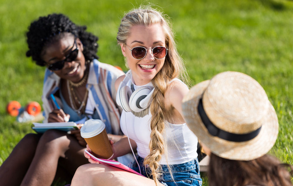 Three women partaking in a small sober event outside