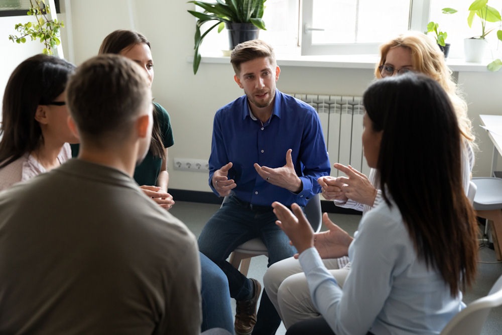 Lively support group for bipolar and addiction meeting indoors