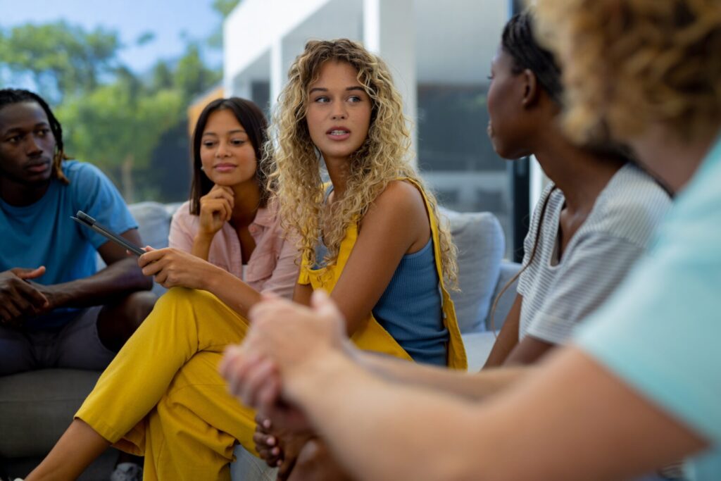 Woman with high-functioning depression chatting with friends in a group outdoors