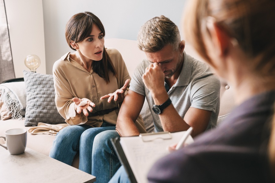 Couple arguing about high-functioning depression in front of therapist