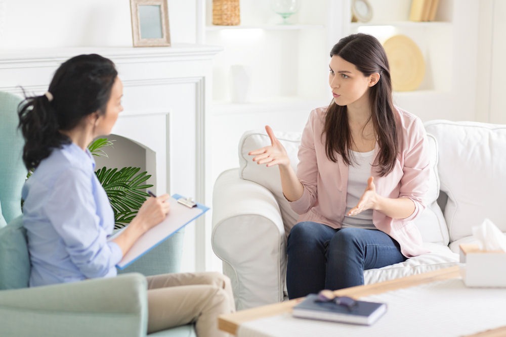 Young woman discusses drunkorexia with therapist