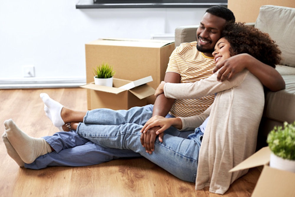 Happy couple embracing in new home after going through family program for addiction