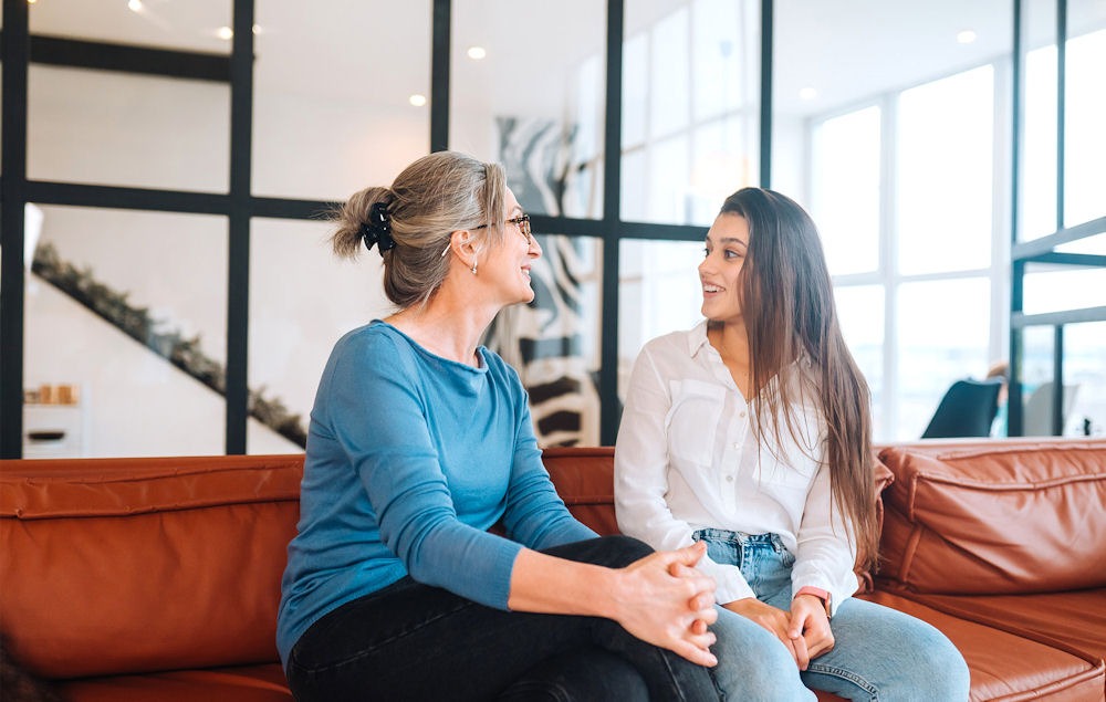 Woman opening up to mother or other older woman about holiday depression