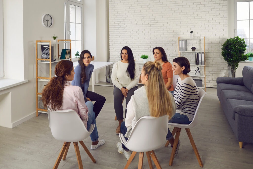 Women in support group discussing depression in early recovery