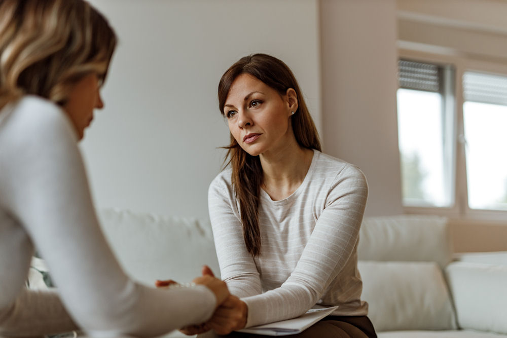 Mother discussing how to love an addict with woman