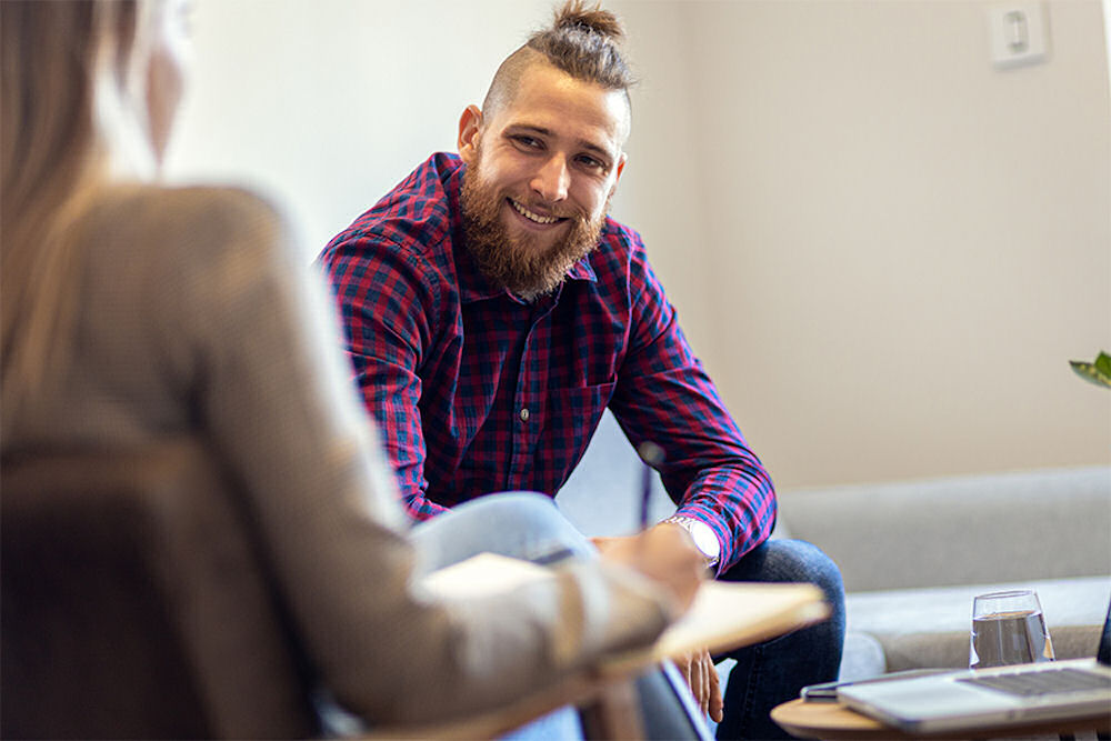 man smiling in individual therapy