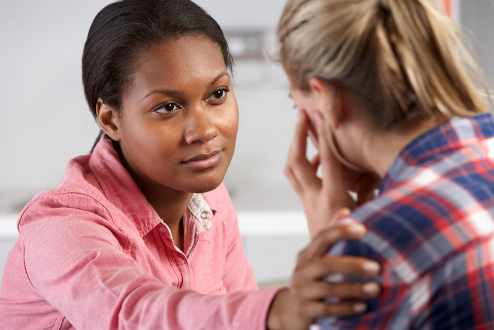 Therapist consoling a crying woman