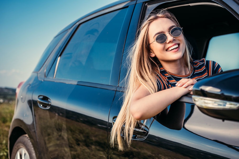 Woman relaxing while looking out the window during a trip celebrating sobriety