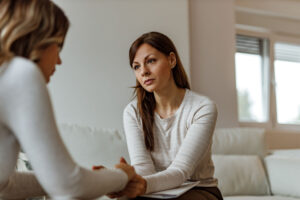 Therapist reassuring woman talking about Mother's Day being difficult