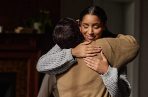 Woman embracing relative in opioid addiction therapy