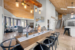 Wide view of dining table, living room, and gourmet kitchen at First Steps Recovery's Cypress Detox Center For Men
