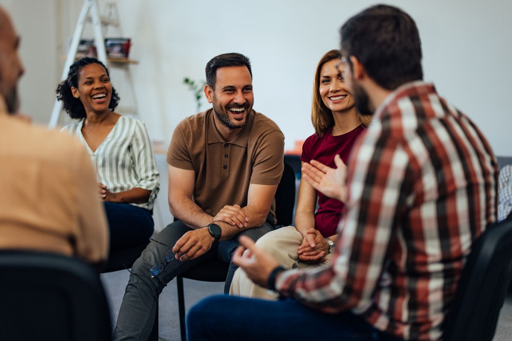 Addiction support group having a lively discussion about what a speedball is.