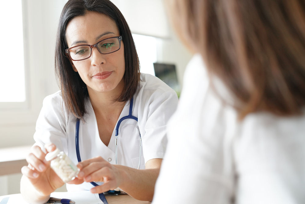 Woman explaining medication and sugar addiction to colleague.