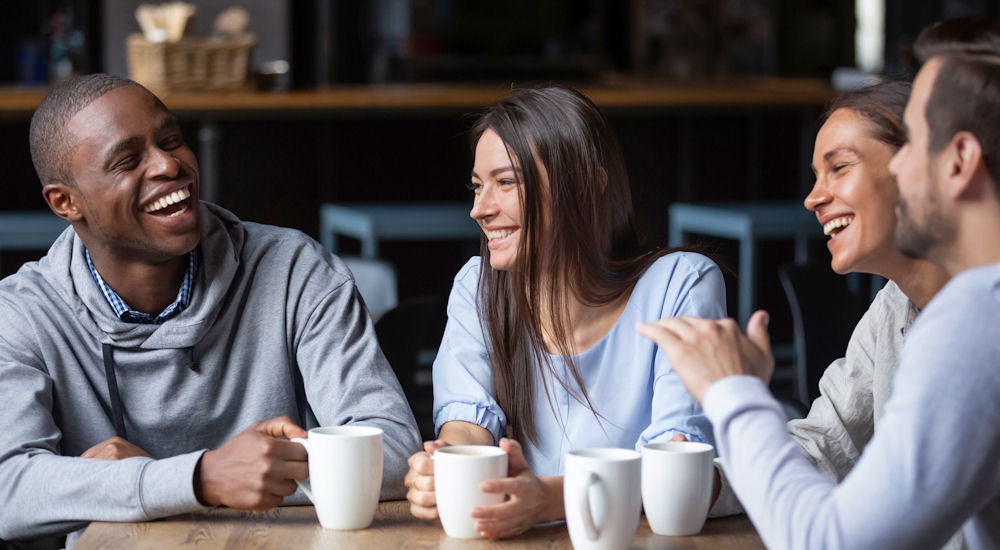 Group of friends hanging out with their bipolar friend with coffee.