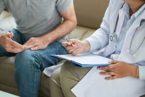 Man consulting with doctor as part of doctor shopping.