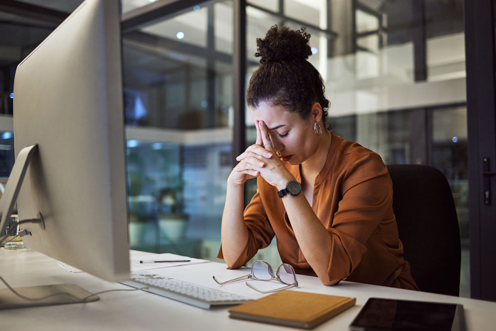 Woman looking down in frustration in learning that their coworker is a chronic liar.