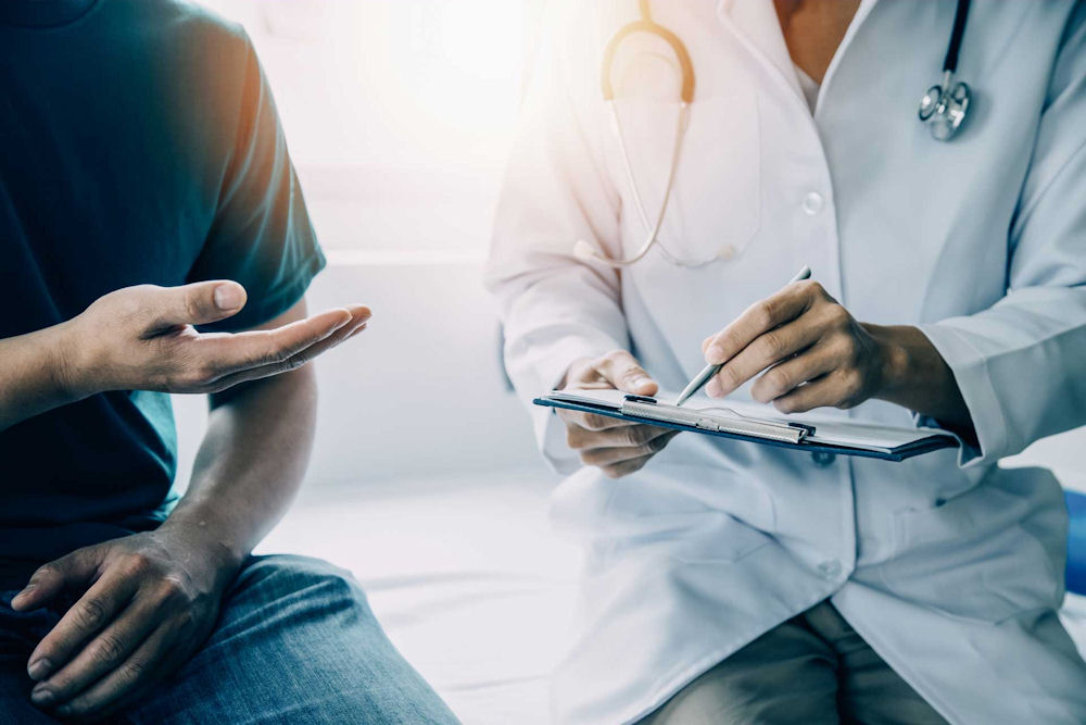 Man consulting with doctor about addiction treatment.