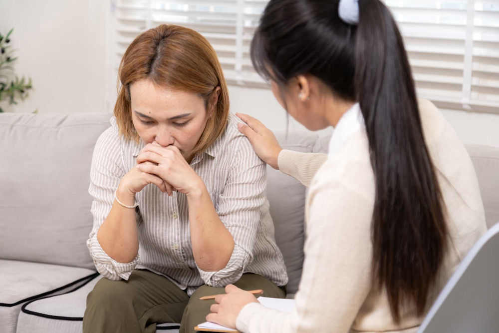 therapist reassuring younger woman about quaaludes addiction.