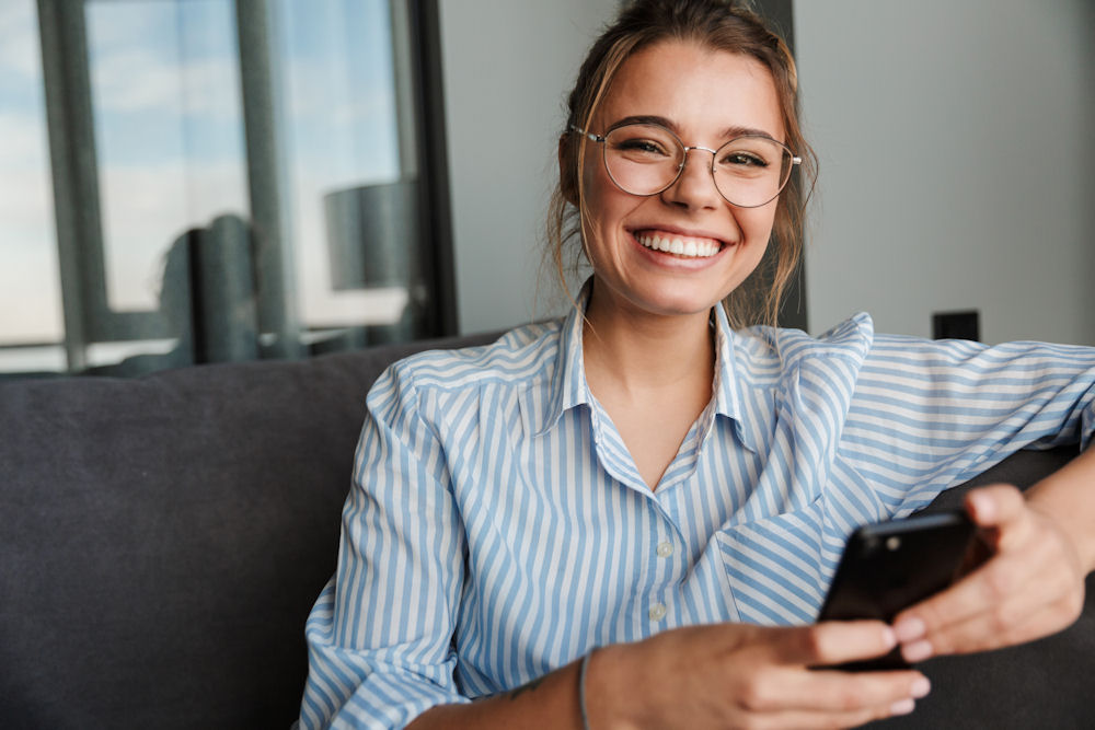 Woman with glasses smiles while discussing Vivitrol for addiction recovery.
